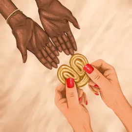 Personne qui donne à une autre un biscuit en forme de cœur. On ne voit que leurs mains et le biscuit.